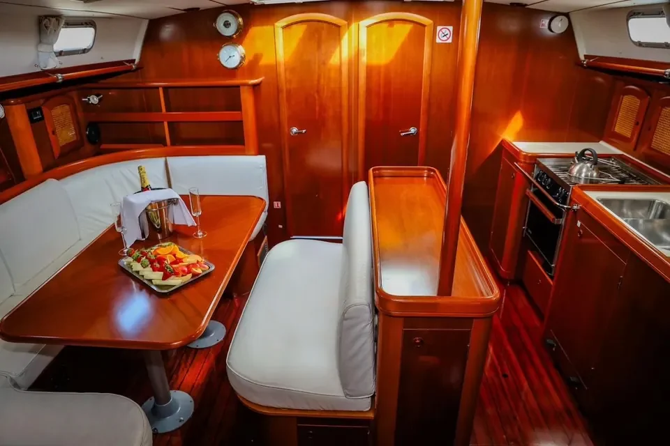 Wood-panelled saloon with dining table on the Beneteau 50